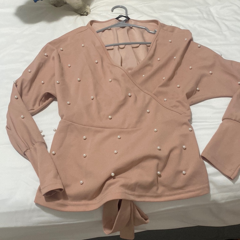 Long-sleeve blush pink, shirt. Pearls are on it securely